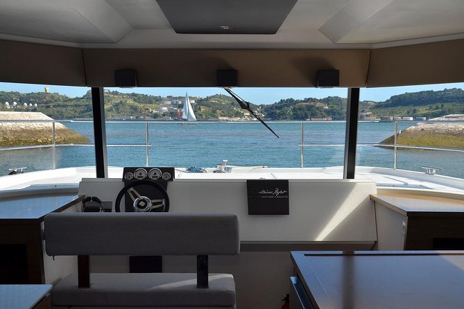1H power catamaran up to 18 people in Lisbon - Under the 25th of April Bridge