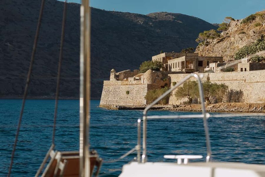 Agios Nikolaos All-inclusive Catamaran Cruise & Water Toys - Sailing past the Cave of Barbarossa