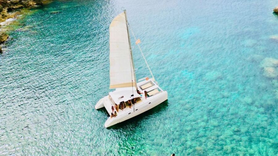 Alghero: Full day on a catamaran in Porto Conte Natural Park - Seeing Capo Caccia from Porto Conte Bay