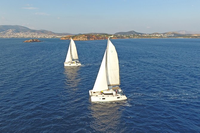 Athens Private Luxury Catamaran Cruise with Traditional Greek Meal and BBQ - Two swimming stops, towels, and snorkeling gear
