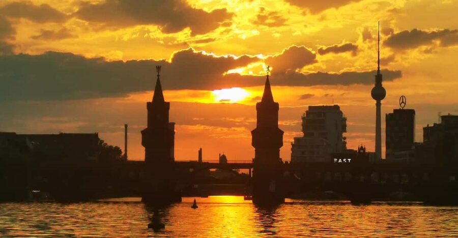 Berlin: Solar Powered Sunset Catamaran Cruise & Audio Guide - Boarding beneath Oberbaumbrücke