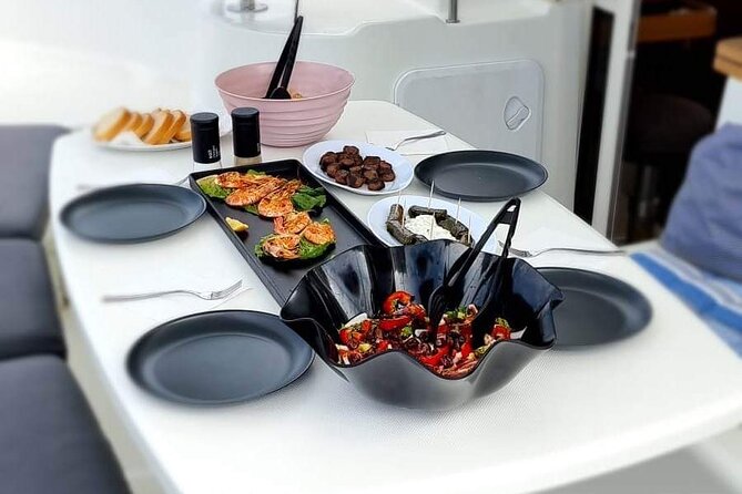 Catamaran Day & Sunset Cruises with meals Drinks and transportation - Passing Baos and the sacred island of Delos