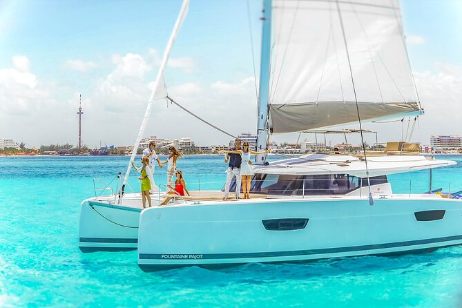 Catamaran to Isla Mujeres Snorkeling Tour with Open Bar and Lunch - Spinnaker, drinks, and the boat’s party side