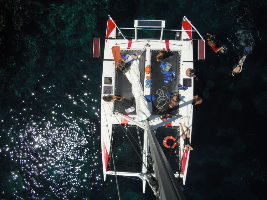 From Fornells: Half-Day Menorca Catamaran Trip w/ Snorkeling - Snorkeling in clear Mediterranean water