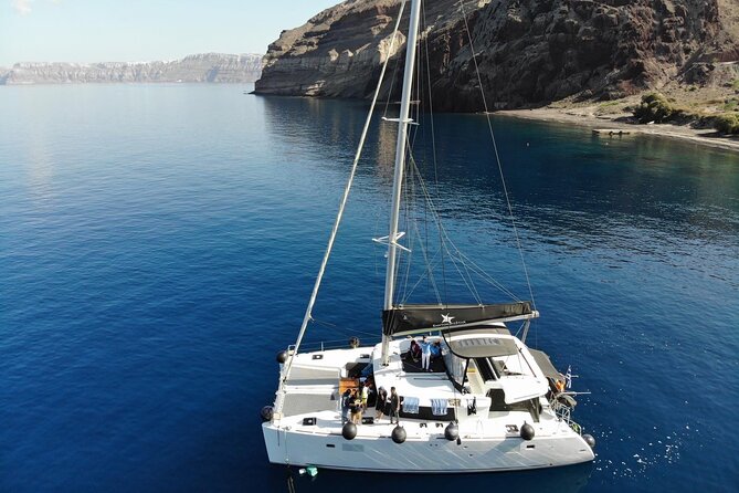 Half-Day Exclusive Catamaran Cruise in Santorini with Meal and Open Bar - Pickup from your hotel to Vlychada Marina