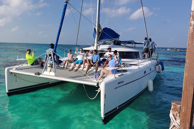 Isla Mujeres: Catamaran Tour with Snorkeling Food, Drinks, Beach - Sailing south with drinks and a social crowd