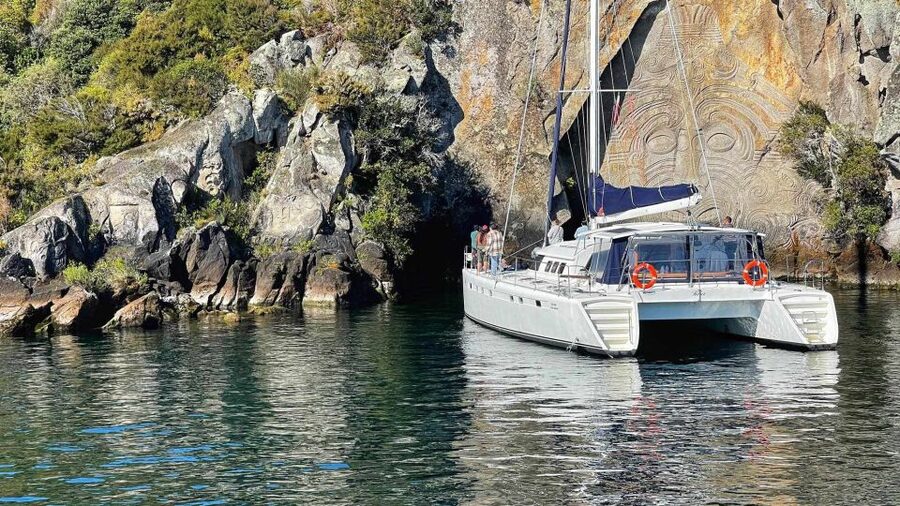Lake Taupo: Luxury Sailing Catamaran to Māori Rock Carvings - The swim stop in a sheltered bay
