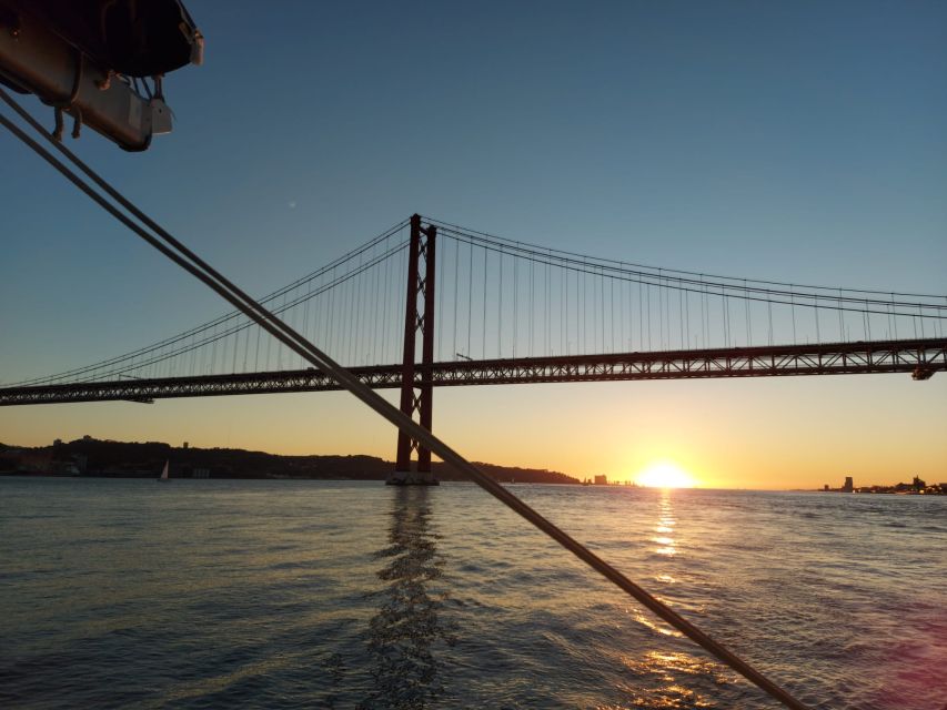 Lisbon: Catamaran Cruise with Drinks & Pastel de Nata - Passing beneath the 25 de Abril Bridge