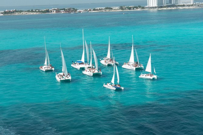 Live this unique experience. Catamaran to Isla Mujeres Tour. Open Bar included. - Open bar, music, and the ride home