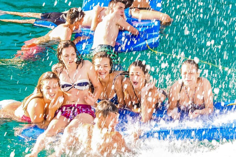 Lloret de Mar: Catamaran Sailing Cruise with BBQ and Drinks - Drinks, music, and the shift from cruise to party