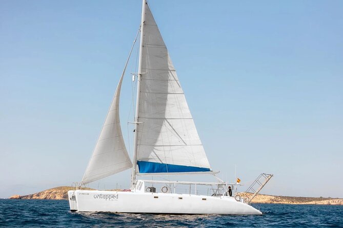 Ocean Catamaran Cruise Ibiza with Unlimited Drinks and BBQ - Cala Bassa and its clear swimming water