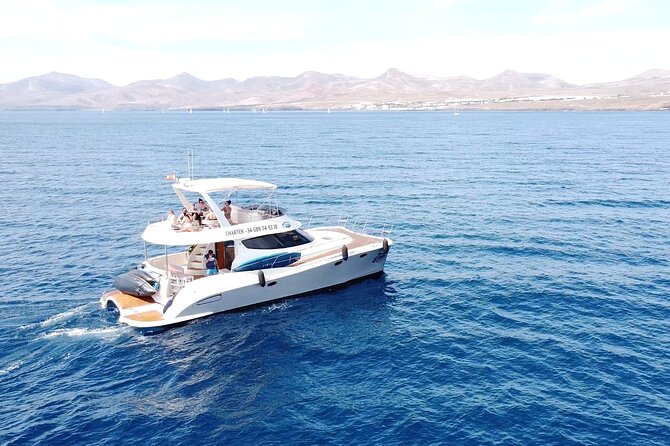 Puerto del Carmen: Catamaran Trip with Water Sports - Leaving Puerto Calero for the volcanic coast