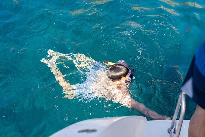 Santorini Adventurous Catamaran Experience with Snorkeling - The Akrotiri lighthouse and volcanic rock formations