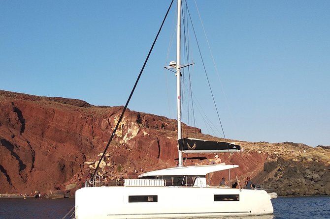 Santorini All-inclusive Private Catamaran Cruise - The Akrotiri lighthouse and the volcanic south coast