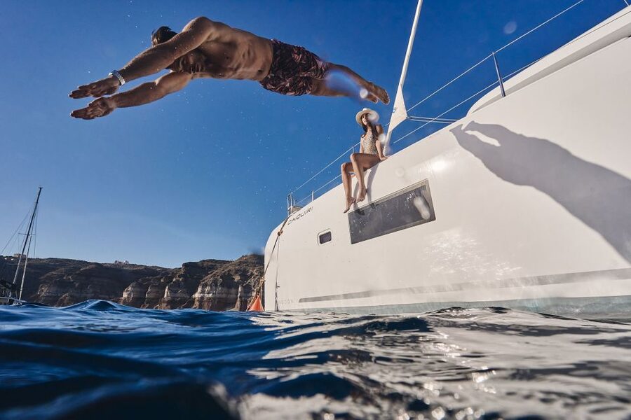 Santorini: Caldera Luxury Catamaran Cruise w/ Meal & Drinks - Red Beach: dramatic rocks and the first swim