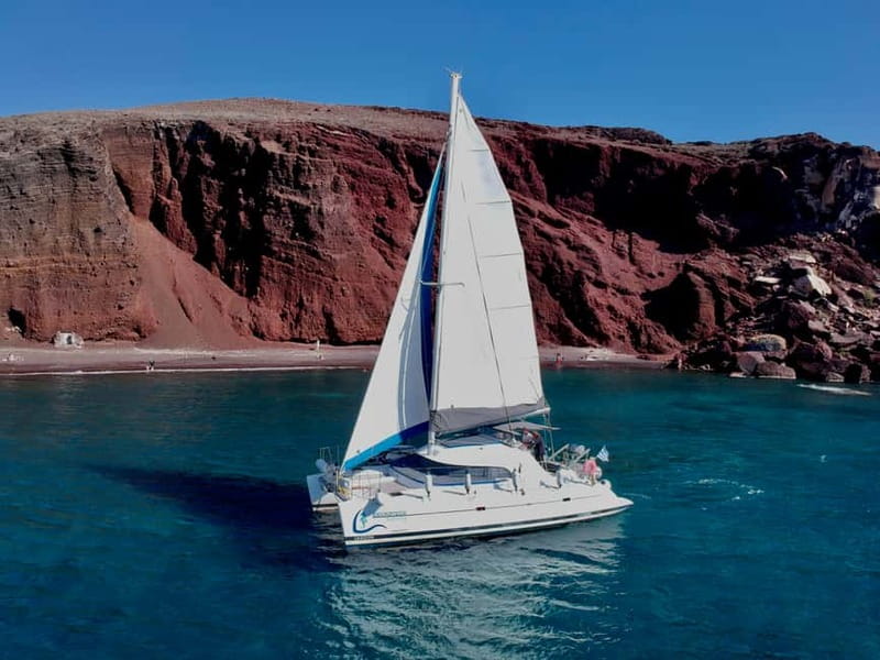 Santorini: Catamaran Cruise with Food and Drinks - White Beach and the southern coast are best from the rail