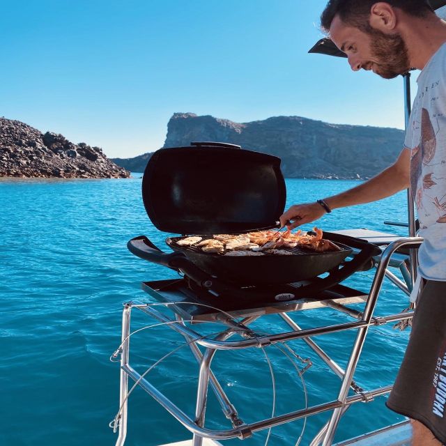 Santorini: Catamaran Cruise with Lunch, Drinks, & Oia Visit - Sailing beneath the Caldera cliffs