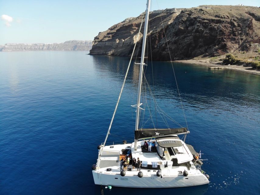 Santorini: Catamaran Cruise with Meal & Open Bar - The Akrotiri lighthouse and the caldera