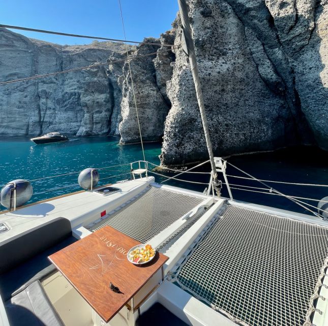 Santorini Catamaran Cruise with Swimming, Meal and Open Bar - Akrotiri Lighthouse and the southern Caldera