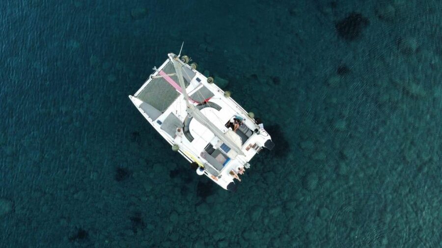 Santorini:Catamaran: private cruise with food & drinks - White Beach, Black Mountain, and Indian rock