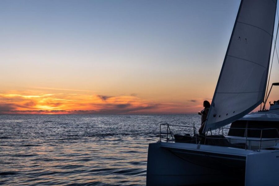 Santorini Catamaran Sunset Skyline Cruise - White Beach, Mesa Pigadia, and the volcanic coast