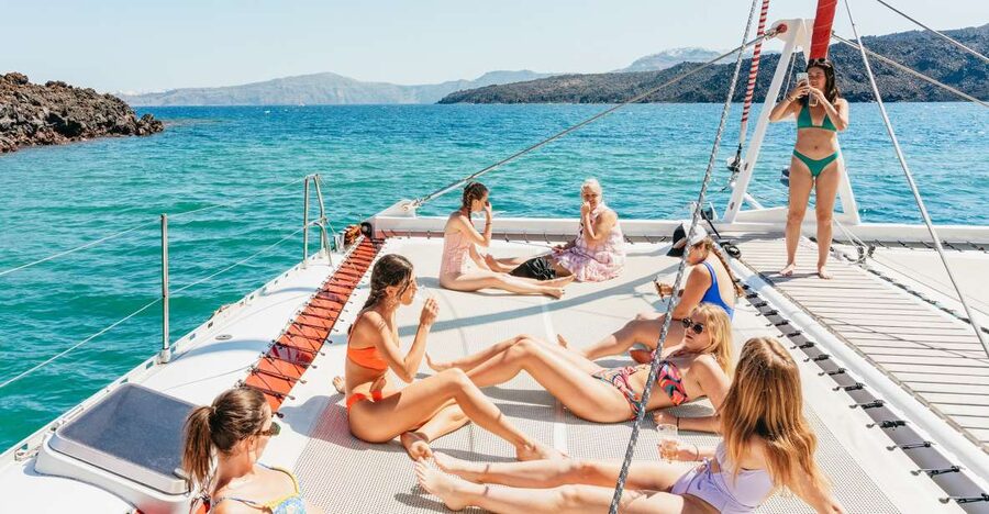 Santorini: Catamaran Tour with BBQ Dinner, Drinks, and Music - Sailing Santorini by catamaran