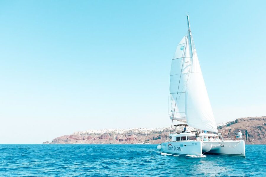 Santorini: Catamaran Tour with BBQ Meal and Unlimited Drinks - White Beach and a BBQ cooked on board