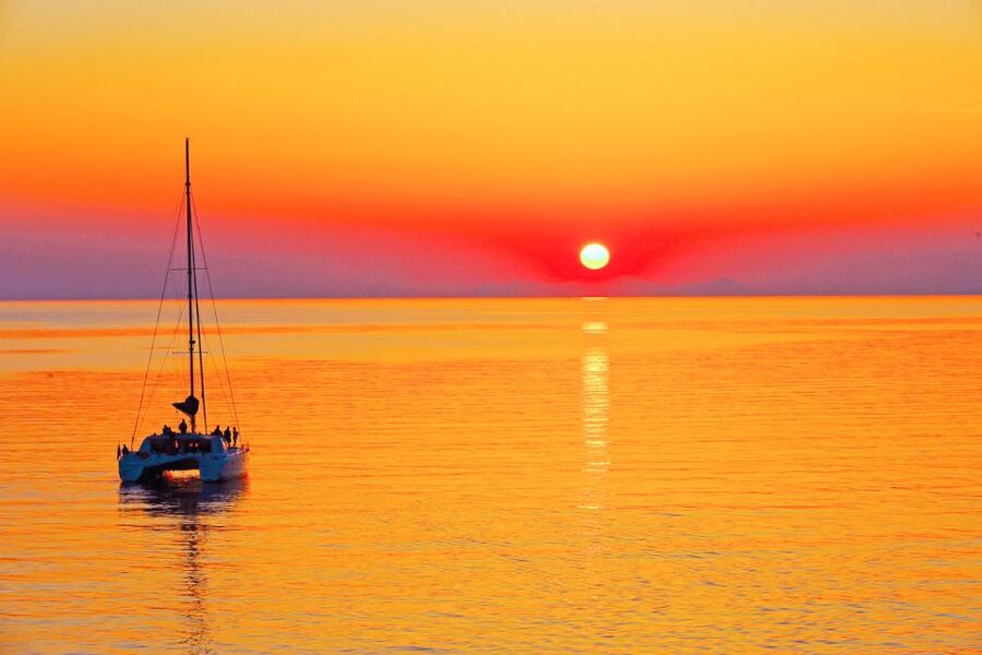 Santorini: Catamaran Tour with BBQ Meal and Unlimited Drinks - Sunset below Oia