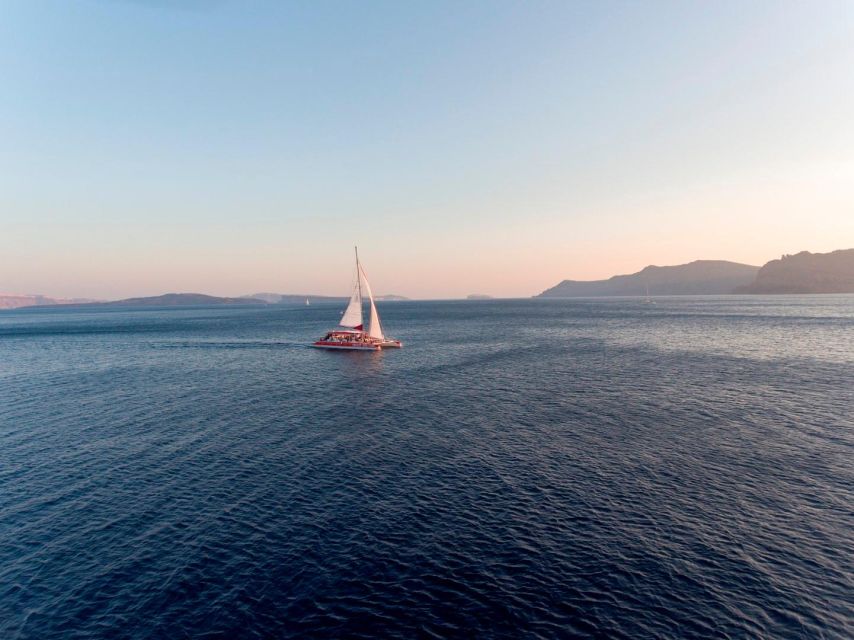 Santorini: Cruise Catamaran with BBQ & Drinks Day or Sunset - Pickup near your hotel and the ride to port