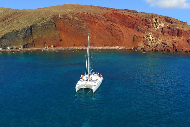 Santorini Full Day Catamaran Private Cruise incl. Meal, Drinks & Free Transport - A full day on Santorini’s volcanic coast