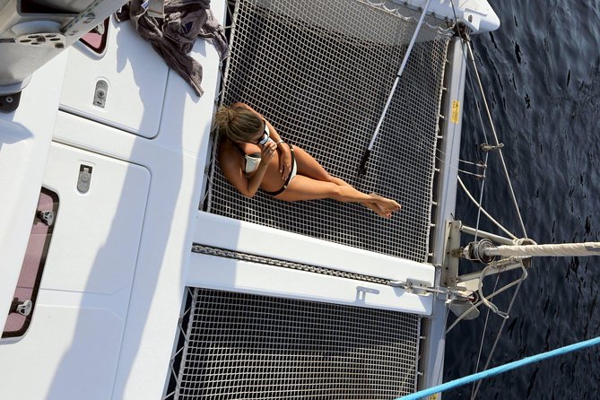 Santorini Full Day Catamaran Private Cruise incl. Meal, Drinks & Free Transport - The Akrotiri lighthouse and the far southwest coast