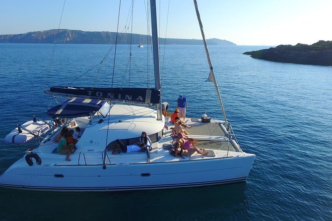 Santorini Full Day Catamaran Private Cruise incl. Meal, Drinks & Free Transport - Mesa Pigadia and the return along the coast