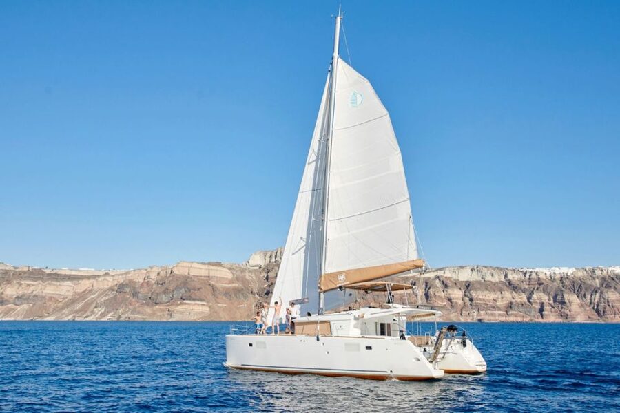 Santorini Gold Catamaran Cruise with Snorkel, BBQ & Open Bar - Caldera cliffs and villages from the water
