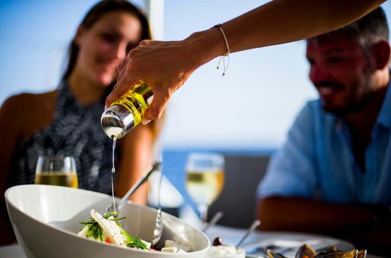 Santorini: Private Catamaran Cruise with BBQ Meal and Drinks - Thirassia and the view toward Manolas