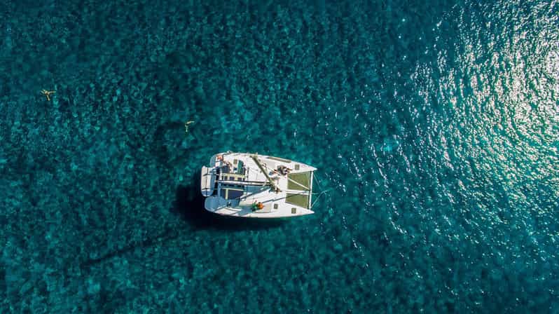 Santorini: Private Catamaran Cruise with Food & Drinks - Cliffs, lighthouse, and the volcanic islands