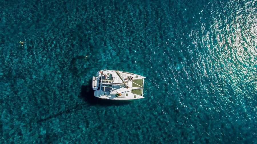Santorini: Private Catamaran Cruise with Food & Drinks - Red Beach and White Beach from the water