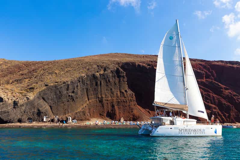 Santorini: Sailing Catamaran Cruise with BBQ and Drinks - Red Beach and the volcanic coast