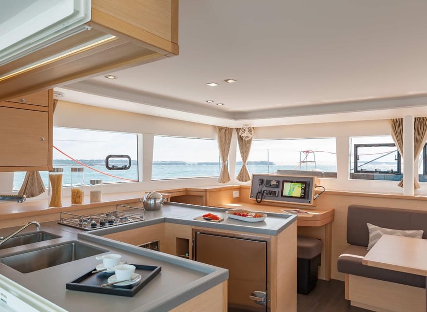 SUP Safari - Catamaran Cruise Dia Island & Gourmet Delights! - Relaxing aboard the catamaran